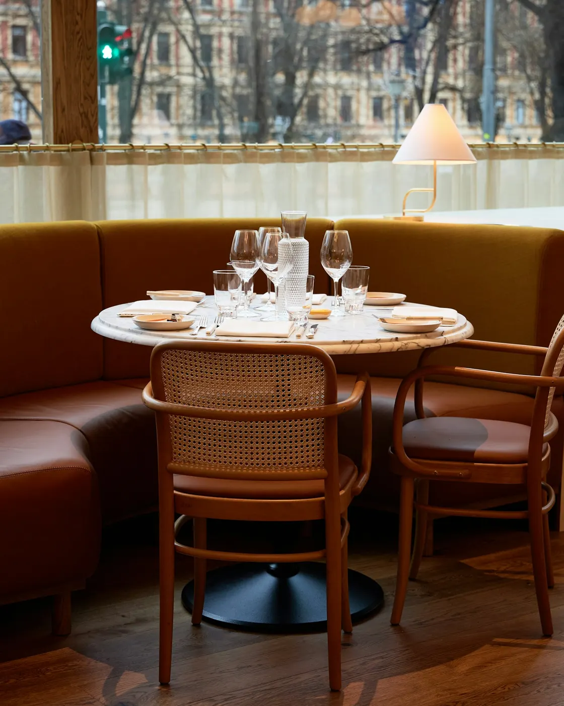 A two-seat restaurant table set beside a window